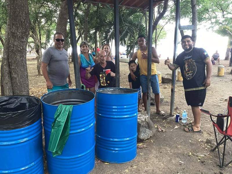 Volunteers next to the blue bins they set up.